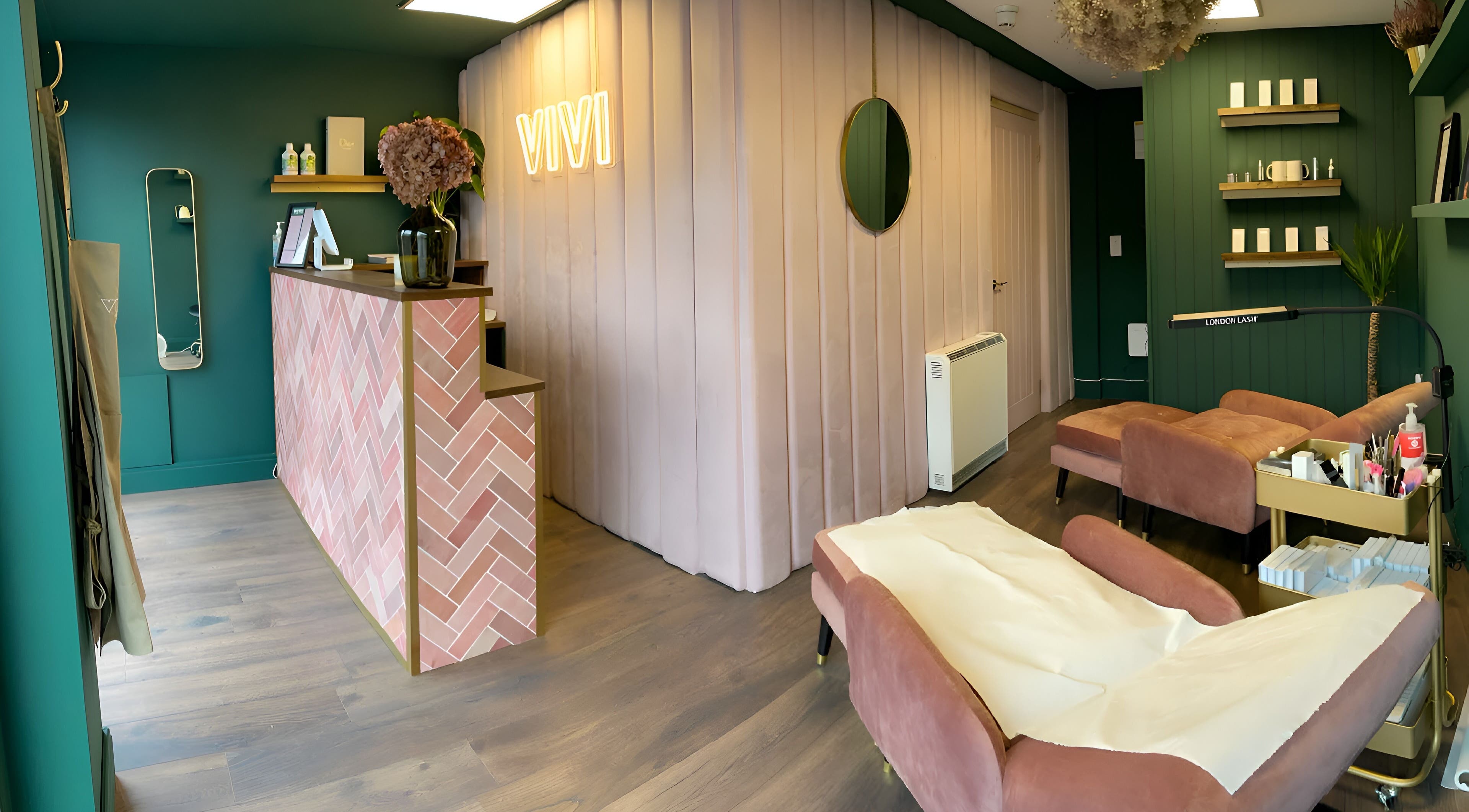 Inviting interior of VIVI Beauty Bar, High Wycombe, England, showcasing stylish pink and green decor.