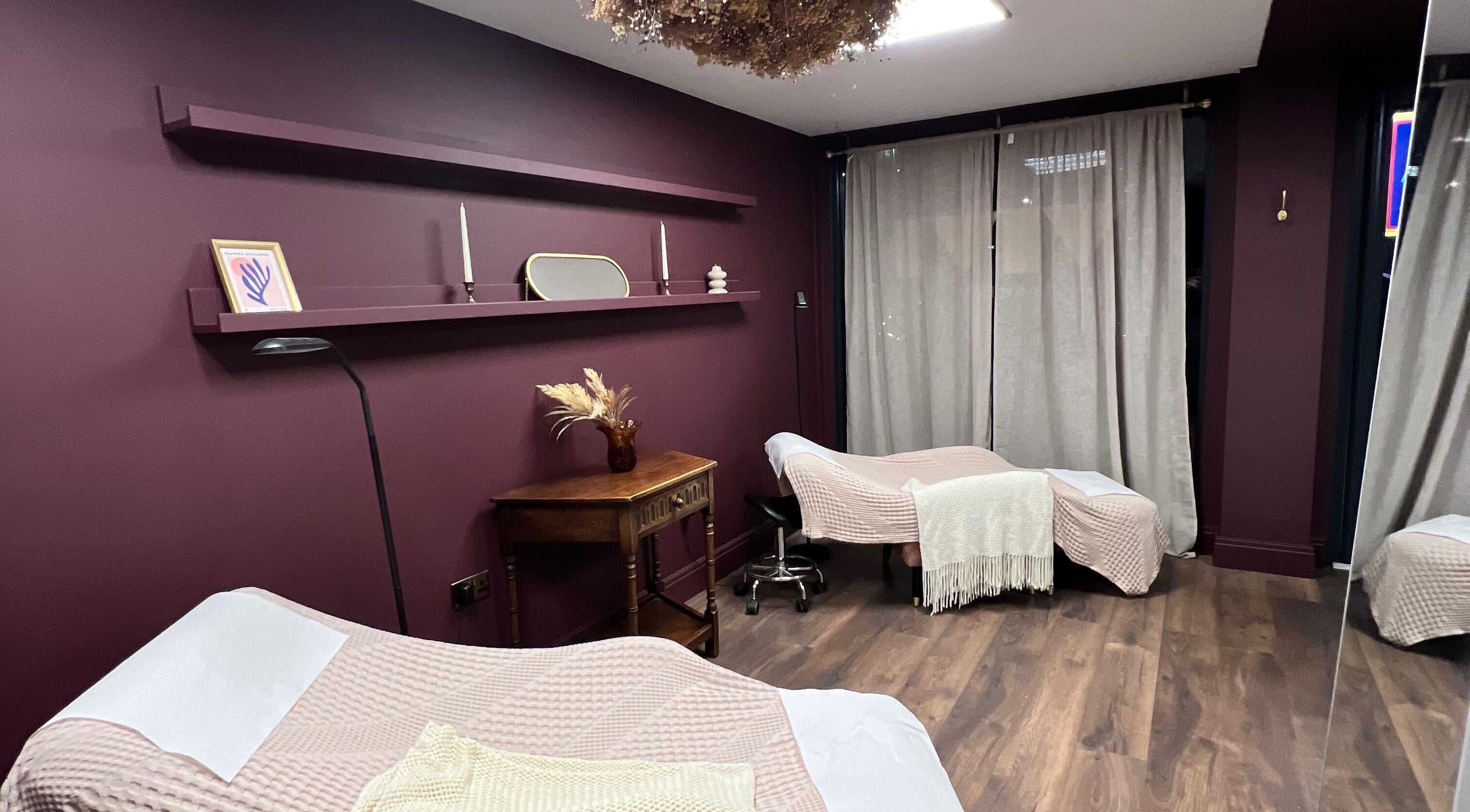 Tranquil treatment room at Core Beauty Studios, High Wycombe, England, GB with elegant decor and cozy beds.