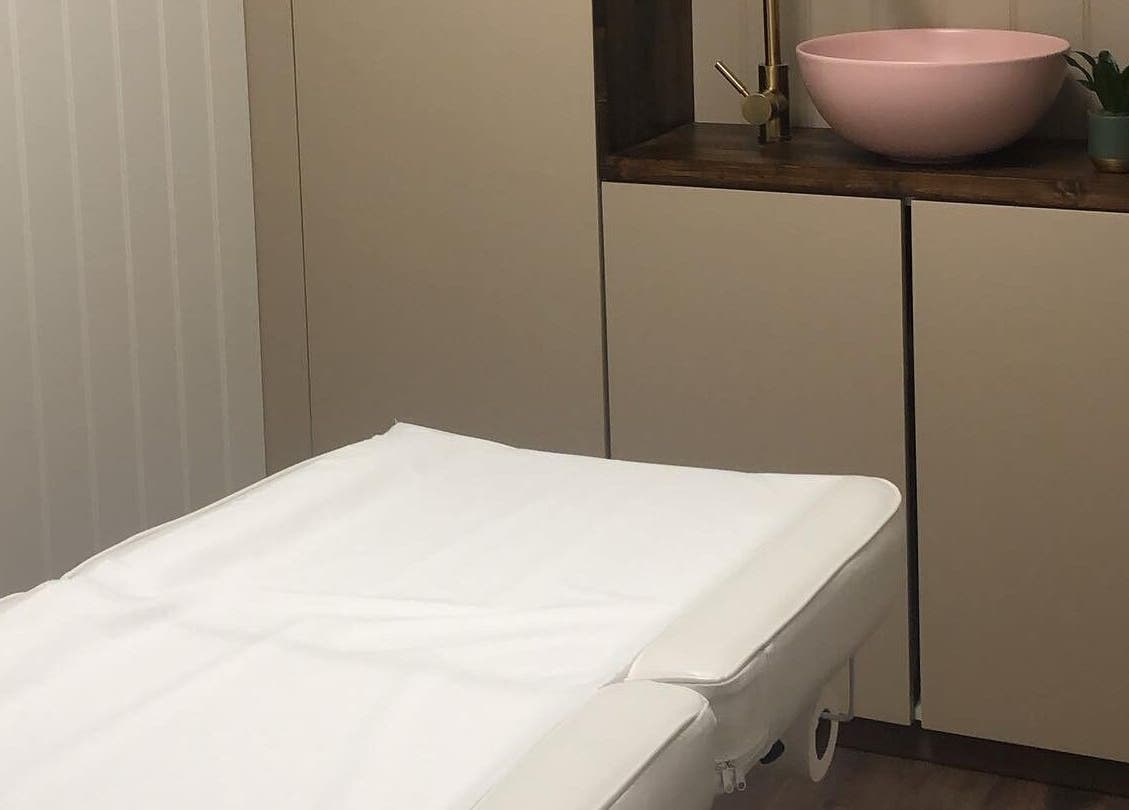 Serene massage room at Core Beauty Studios, High Wycombe, England, GB featuring a plush table and calming decor.