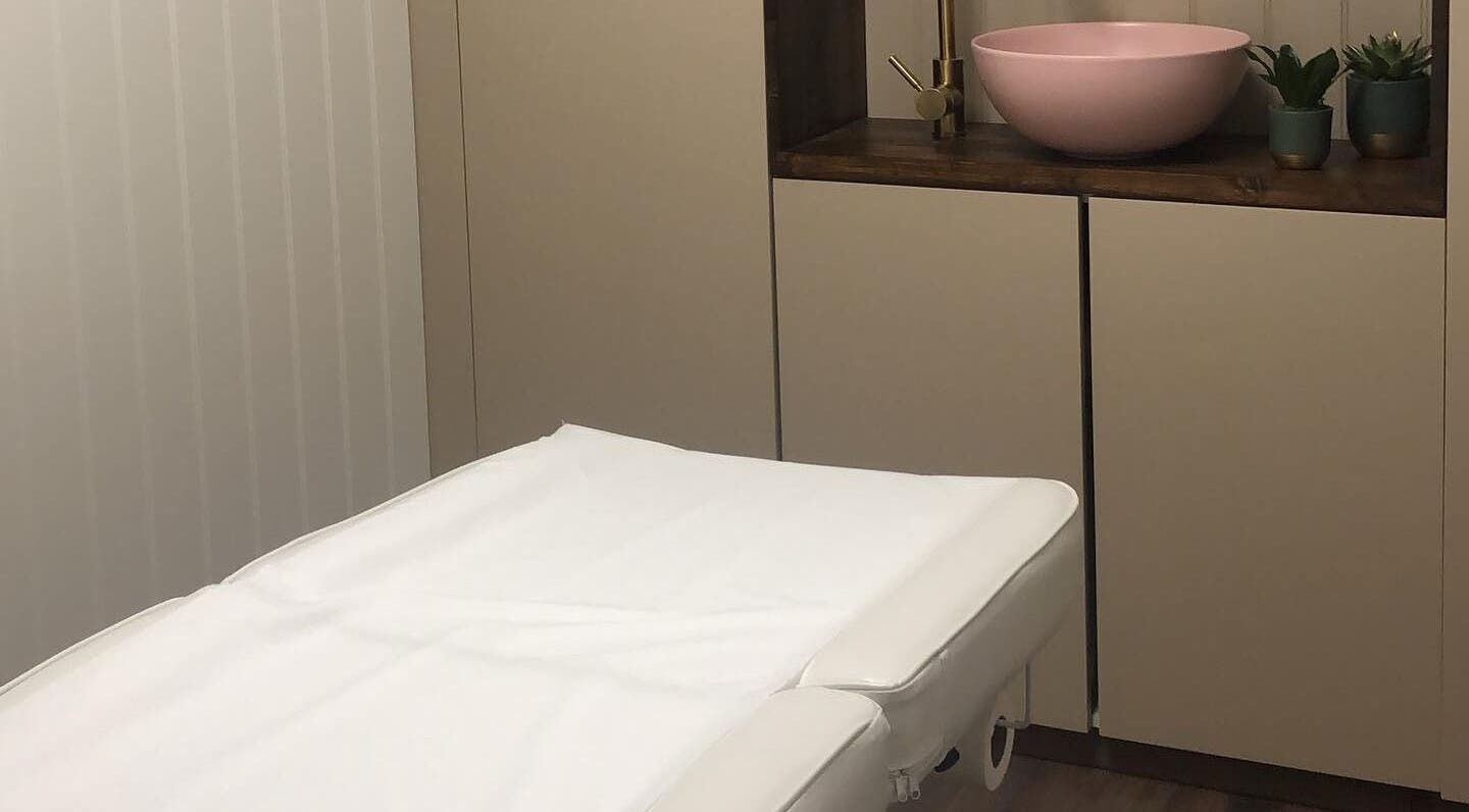 Serene massage room at Core Beauty Studios, High Wycombe, England, GB featuring a plush table and calming decor.