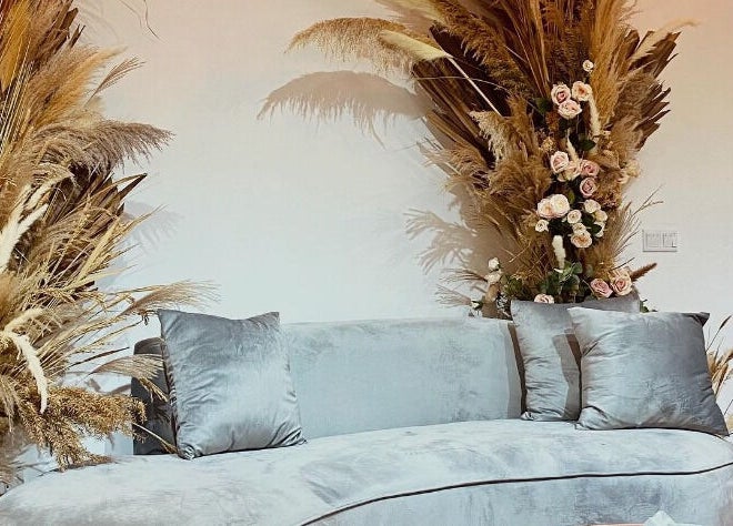 Elegant lounge at MIMONE Spa Bangsar with gray sofa and floral decor in Kuala Lumpur, Wilayah Persekutuan Kuala Lumpur, MY.