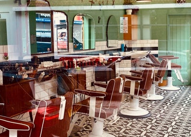A classic barbershop interior at Barber Streisand, London, England, GB with vintage chairs and mirrors.