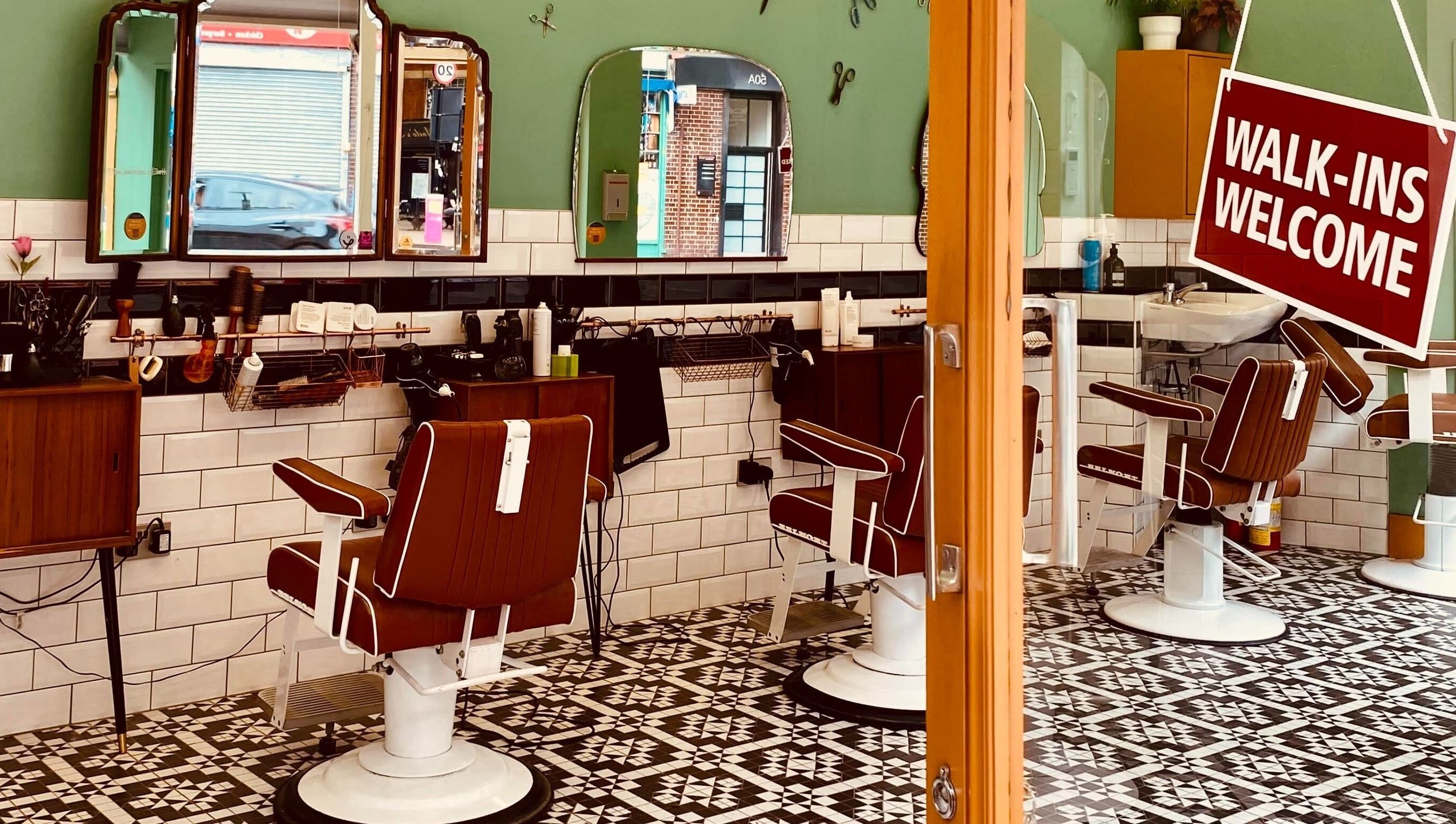 Stylish barber chairs in Barber Streisand, London, England, GB inviting with a warm, vintage interior.
