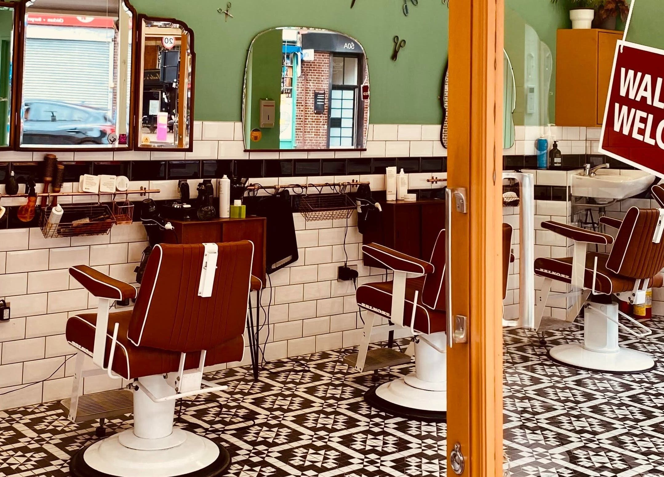 Stylish barber chairs in Barber Streisand, London, England, GB inviting with a warm, vintage interior.