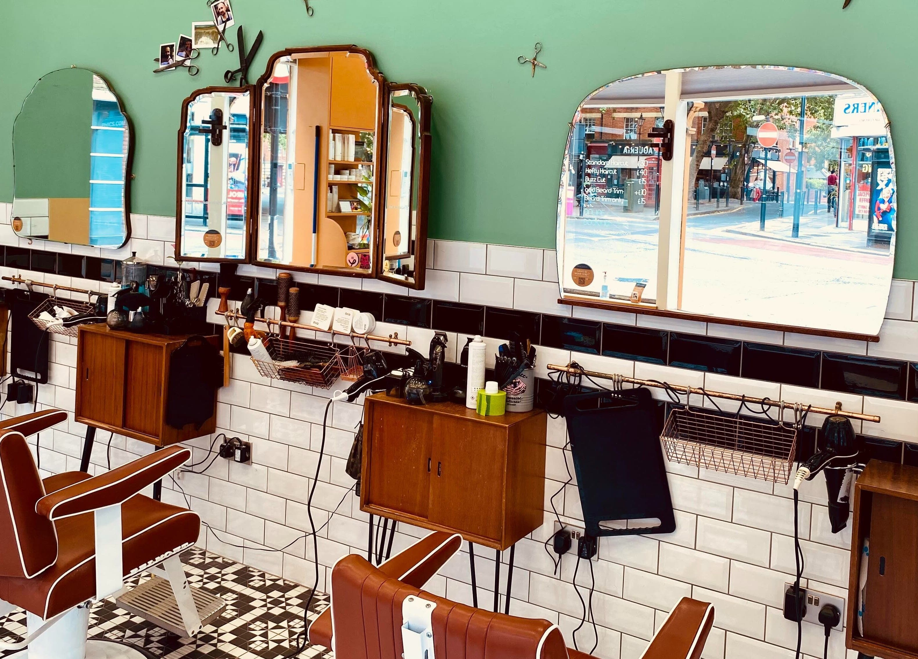 Stylish interior of Barber Streisand, London, England, GB with vintage barber chairs and mirrors.