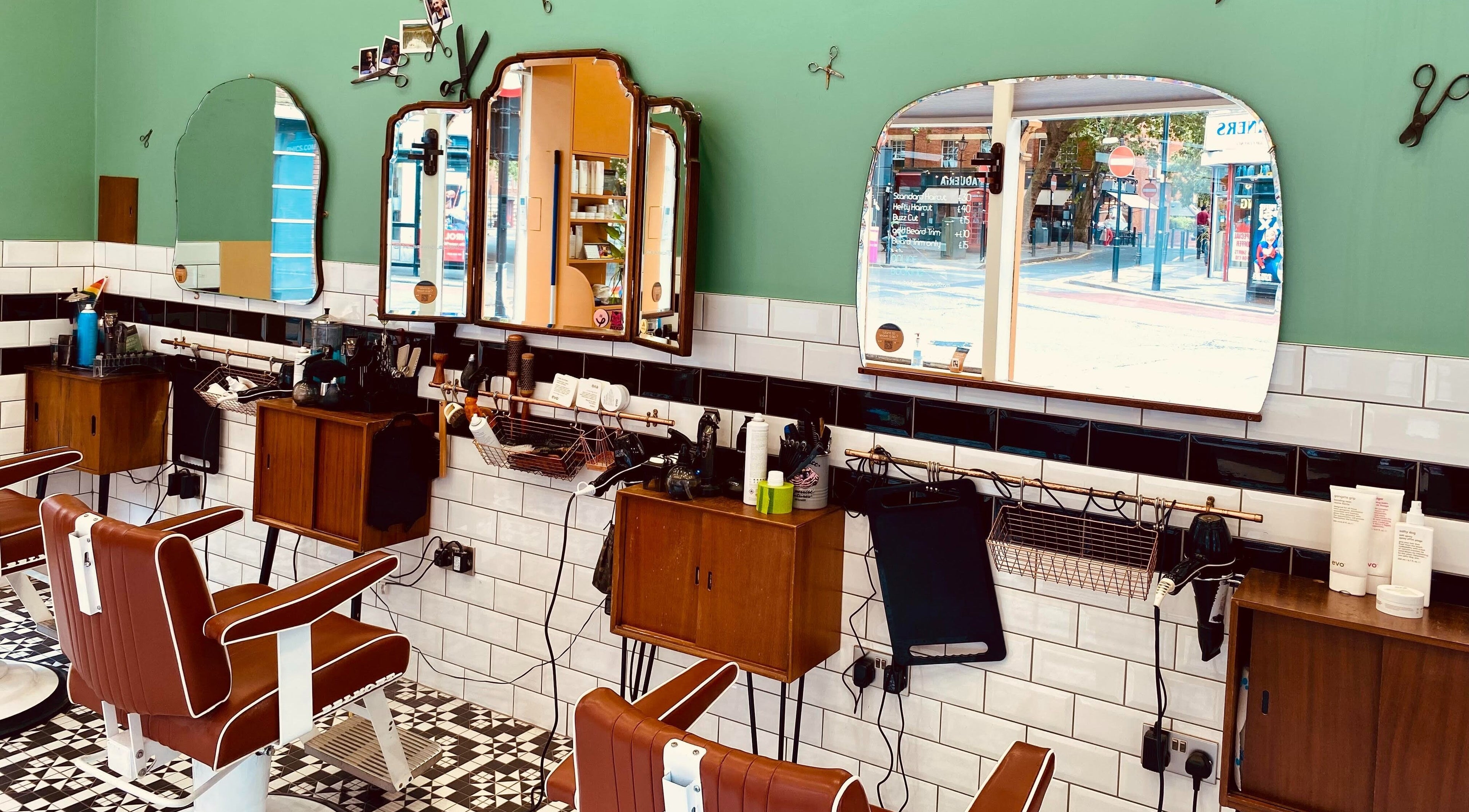 Stylish interior of Barber Streisand, London, England, GB with vintage barber chairs and mirrors.
