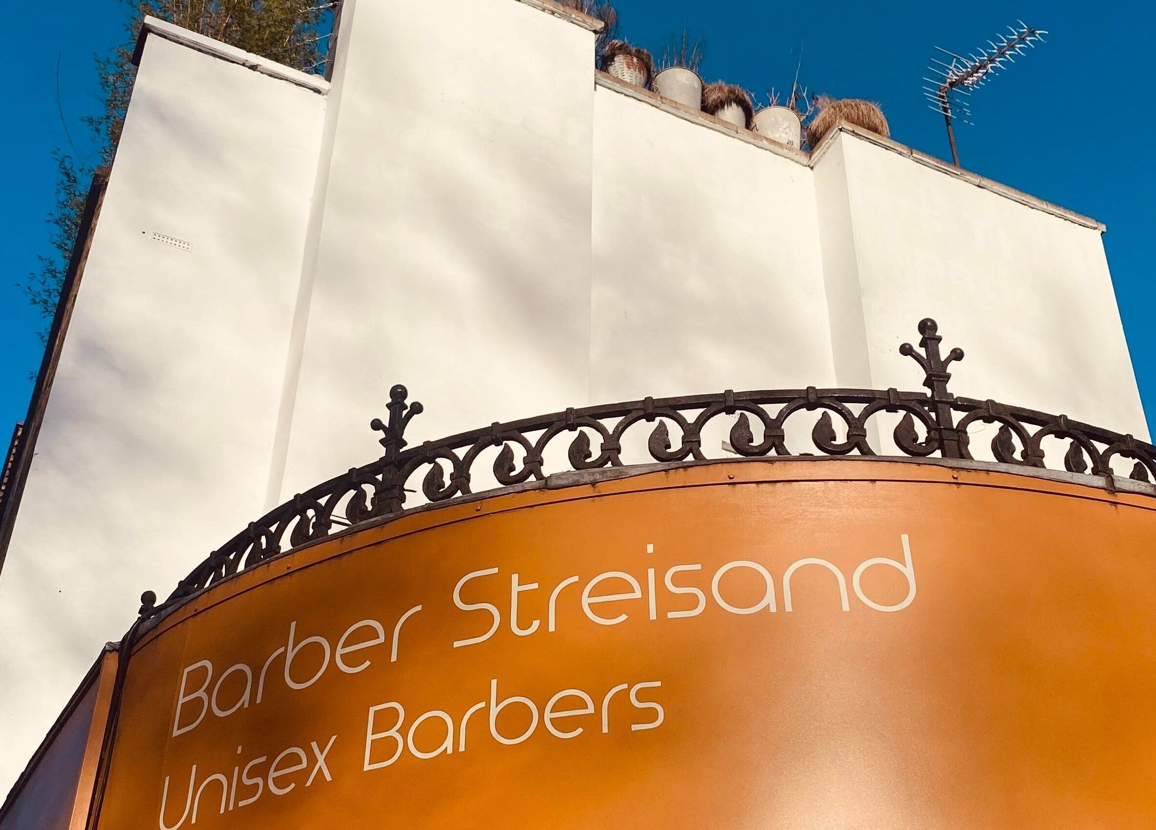 Exterior of Barber Streisand in London, England, GB with stylish beige facade.