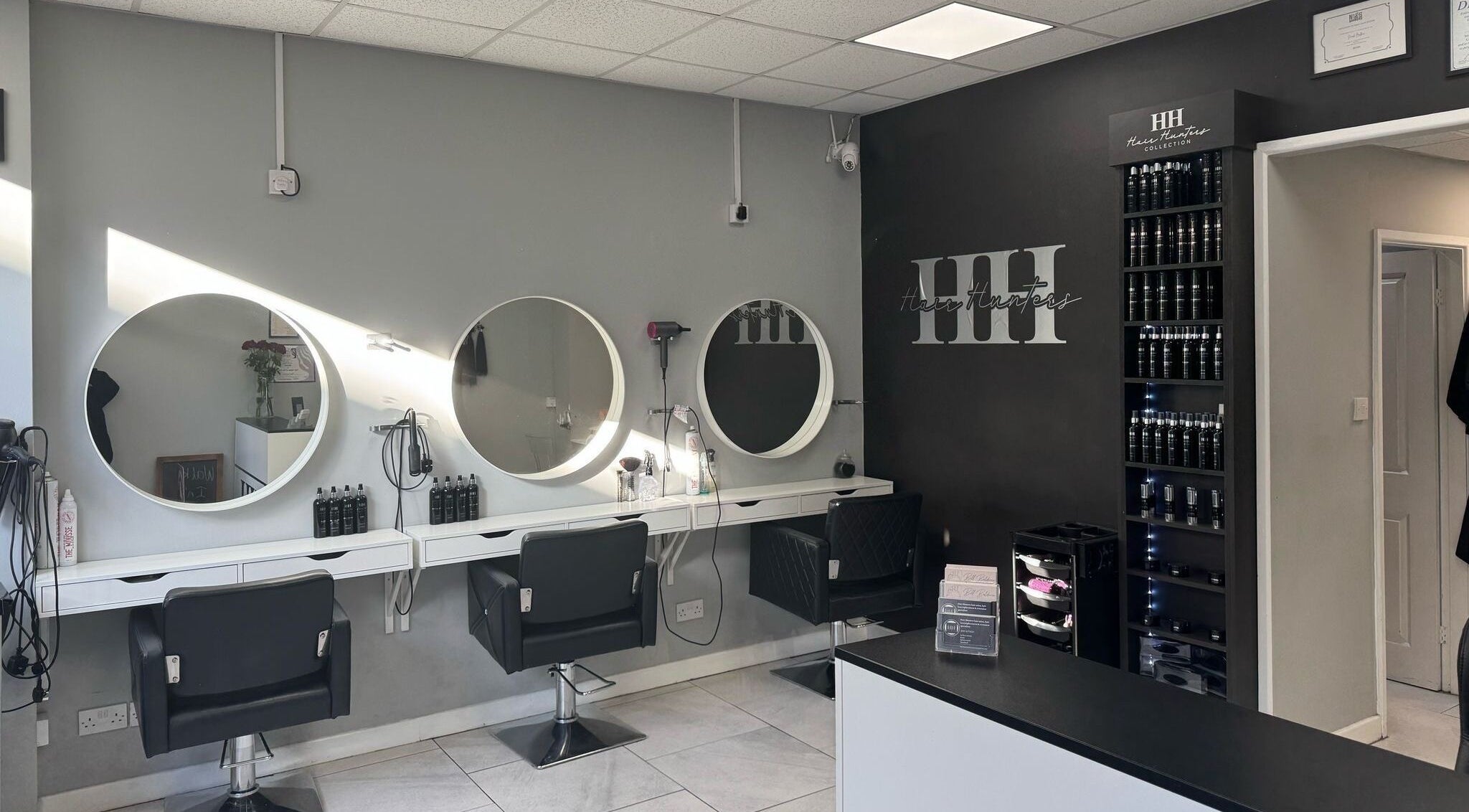 Interior of Hair Hunters Hair Salon in Gateshead, England, featuring styling stations and modern decor.