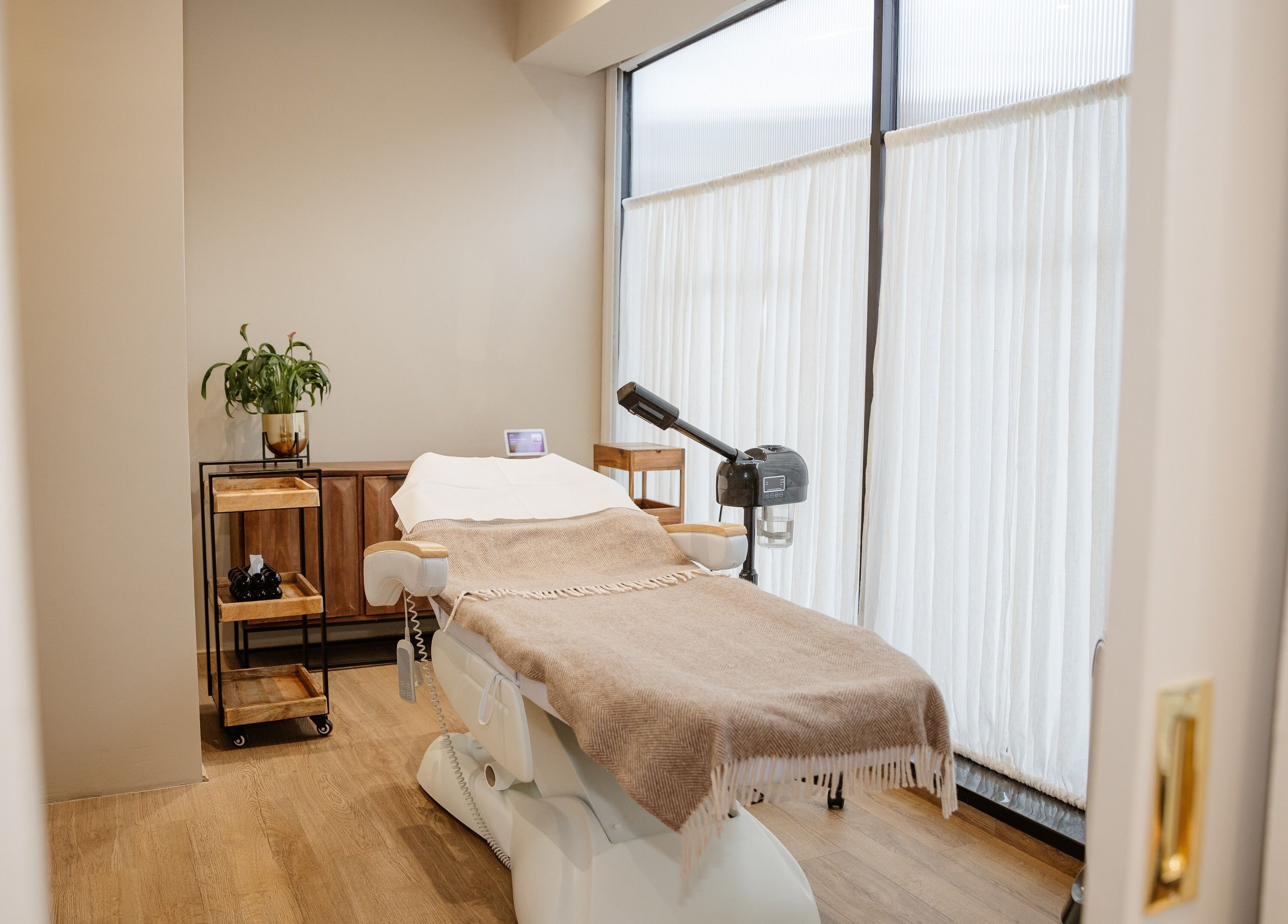 Tranquil treatment room at EGP Aesthetics, London, England, GB with a cozy massage table and modern decor.