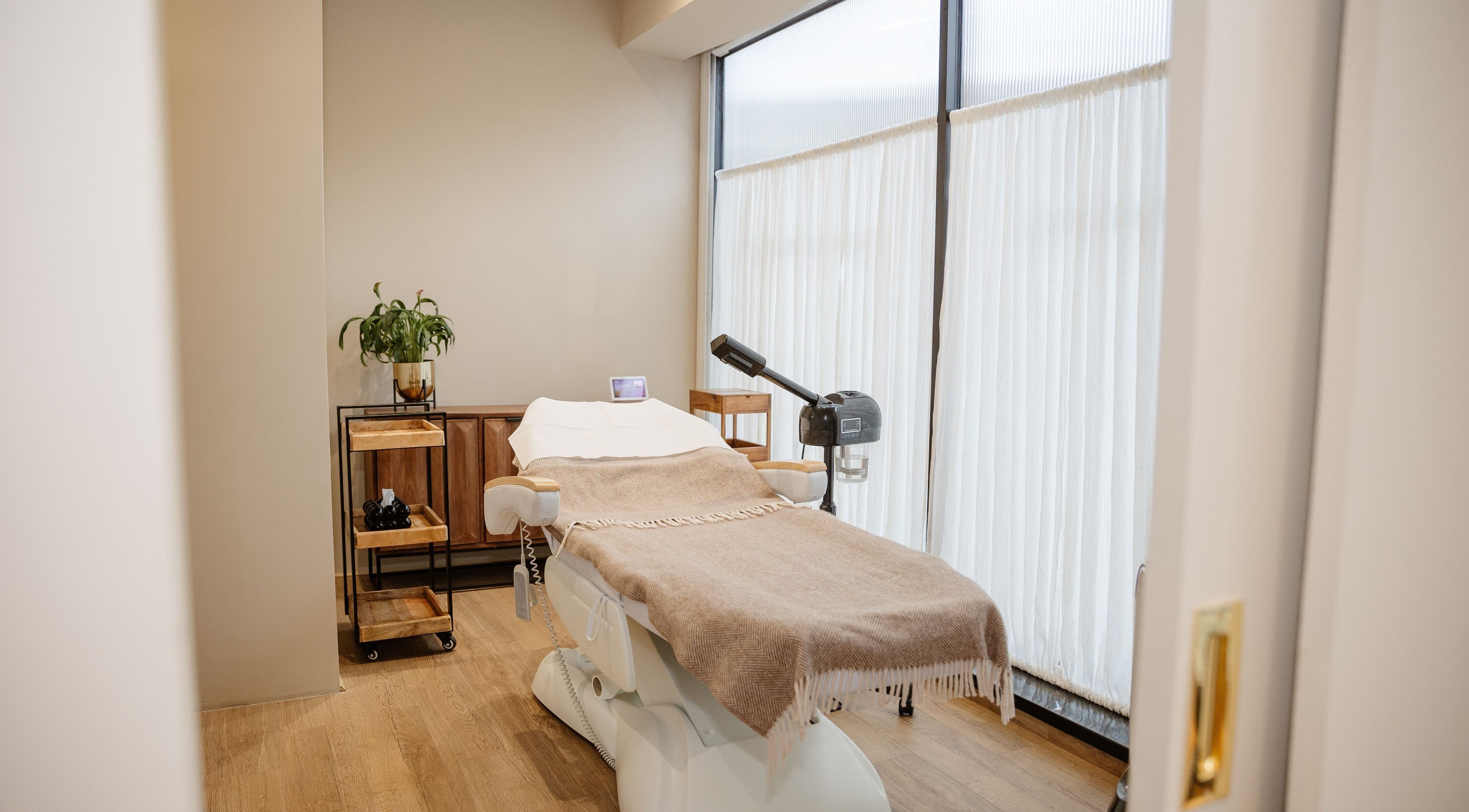 Tranquil treatment room at EGP Aesthetics, London, England, GB with a cozy massage table and modern decor.