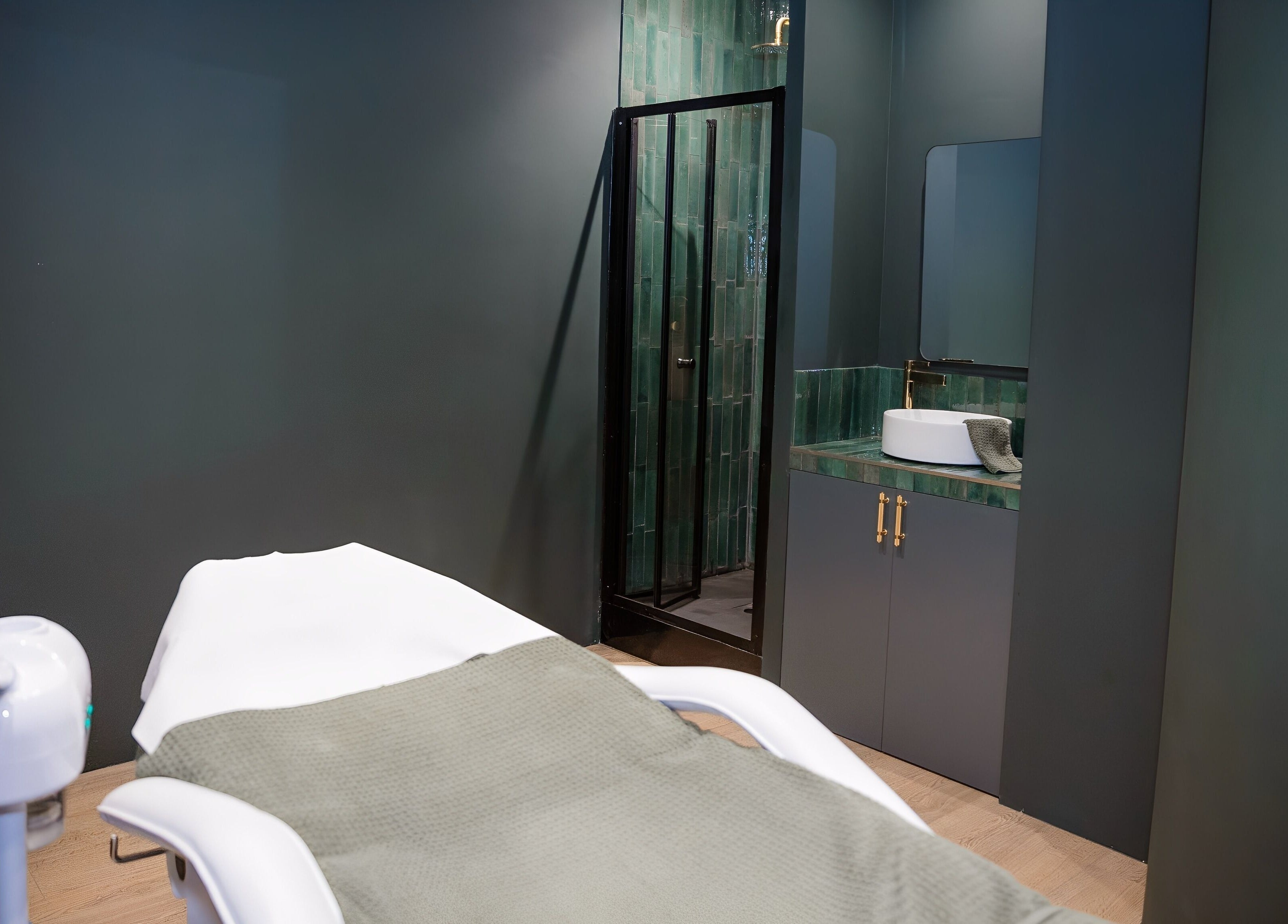 Treatment room with spa bed and modern decor at EGP Aesthetics, London, England, GB.