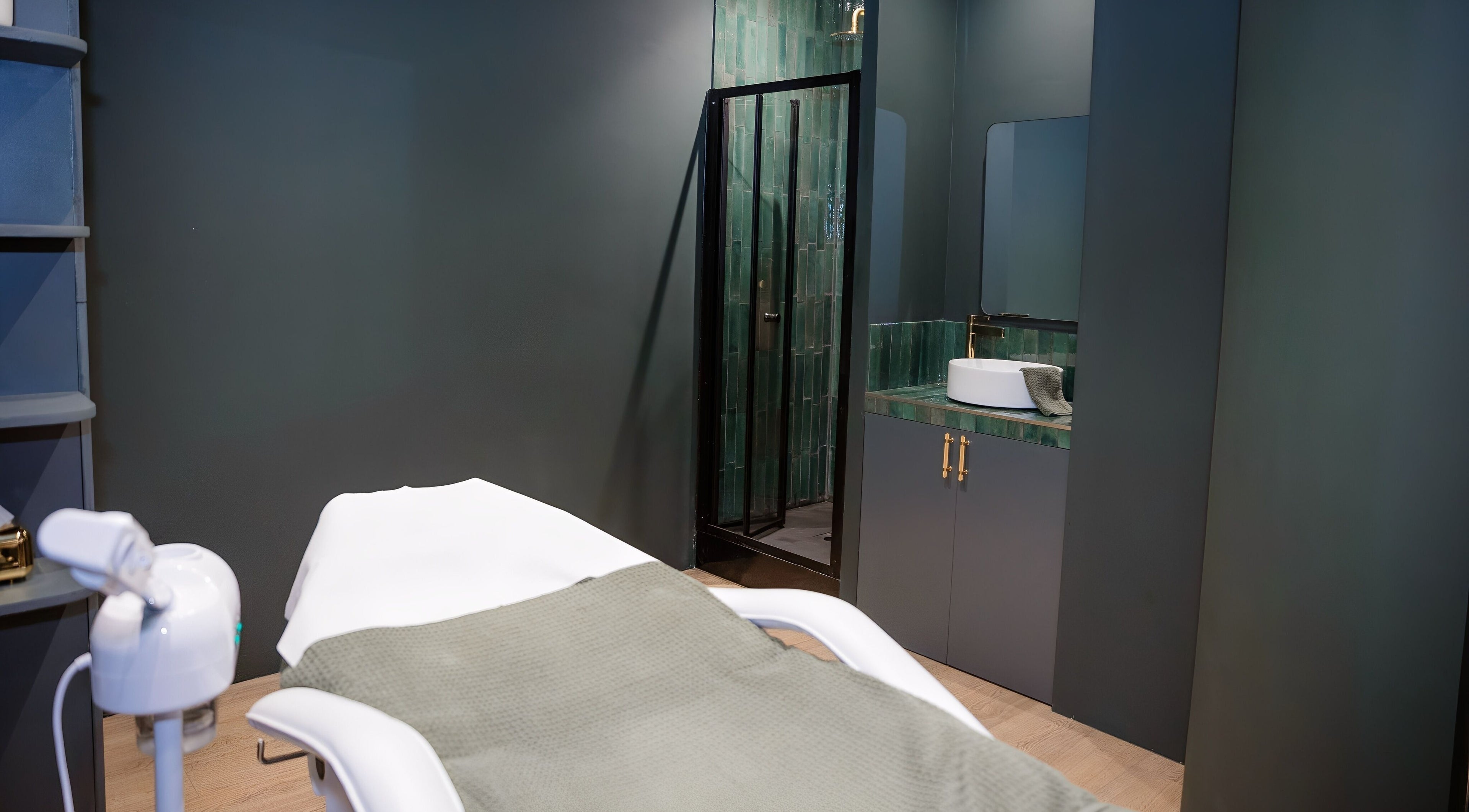 Treatment room with spa bed and modern decor at EGP Aesthetics, London, England, GB.