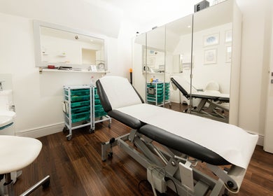 Serene treatment room at Barbanente Clinic, London, England, GB, featuring a comfortable treatment bed.