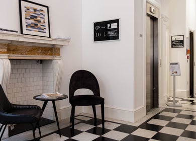 Stylish nook at Barbanente Clinic, London, England, GB featuring chairs and modern decor for client relaxation.