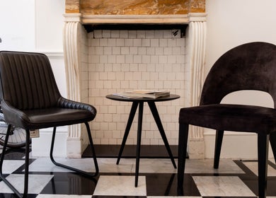 Modern seating area at Barbanente Clinic, London, England, GB. Stylish chairs and table enhance the wellness vibe.