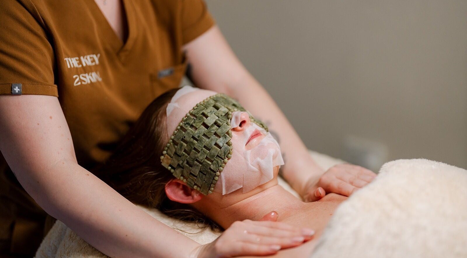 Facial treatment at The Key 2 Skin, Richmond, NSW, with soothing stone mask for relaxation and rejuvenation.