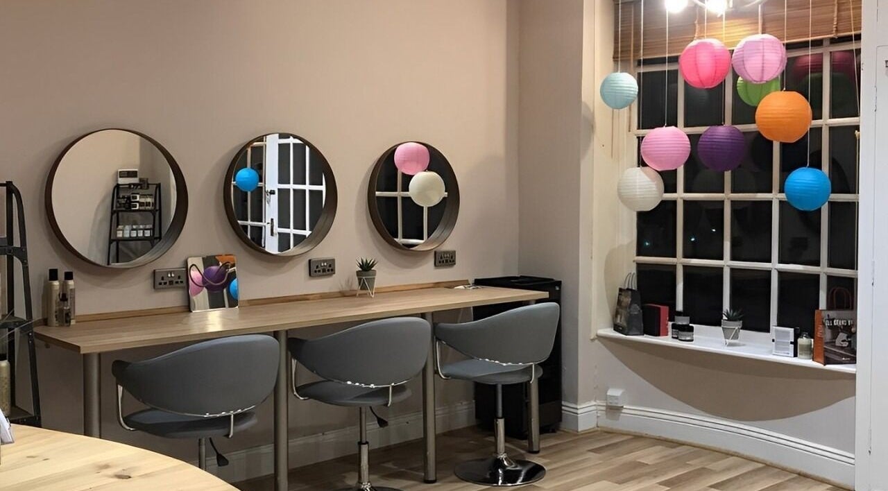 Elegant hairdressing station at Nineteen:2 Hairdressing, Roos, England, featuring modern chairs and vibrant decor.