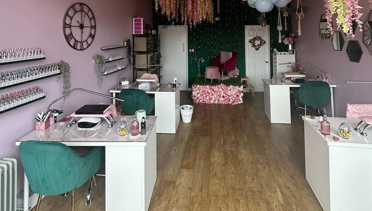 Elegant Hello Beautiful salon in Lytham, England featuring modern nail stations and floral decor.