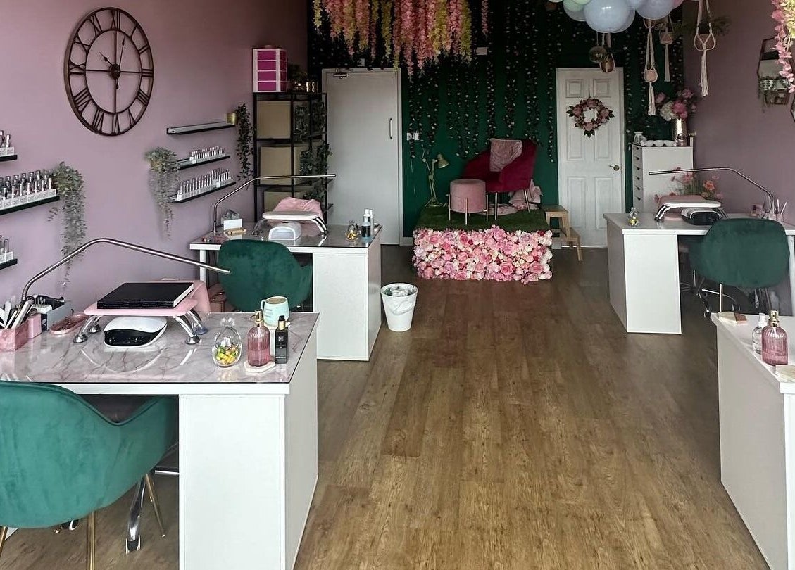 Elegant Hello Beautiful salon in Lytham, England featuring modern nail stations and floral decor.