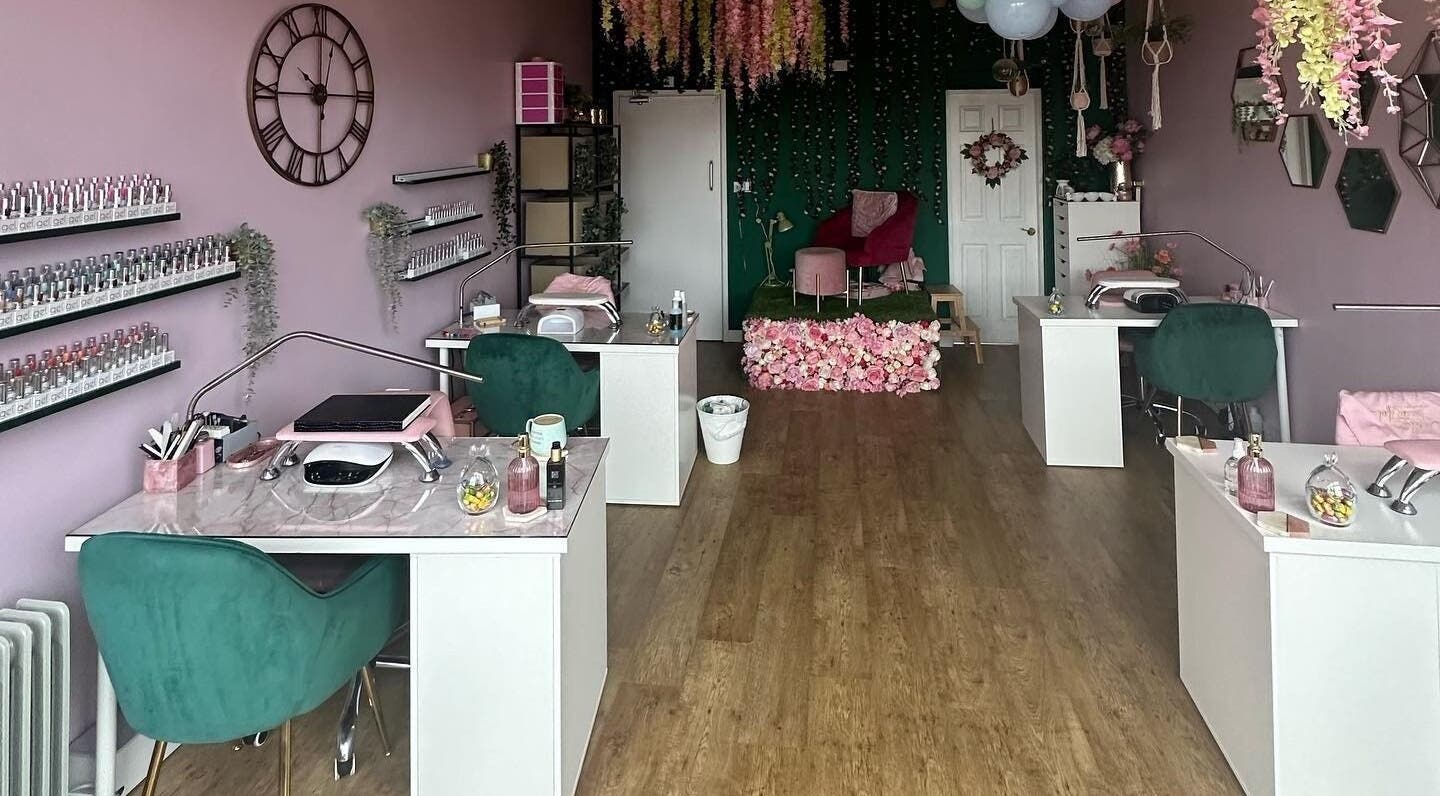 Elegant Hello Beautiful salon in Lytham, England featuring modern nail stations and floral decor.