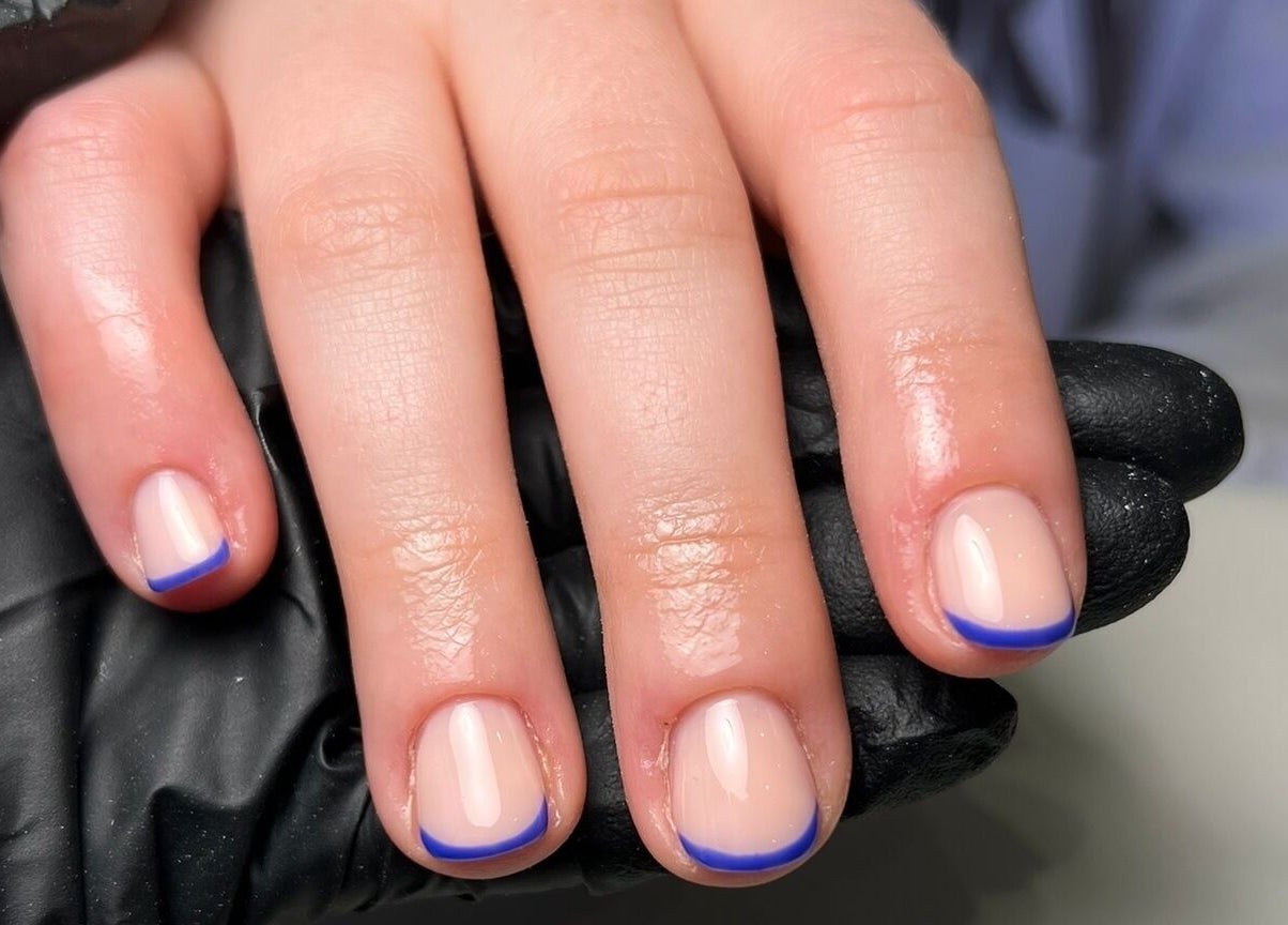 Elegant blue-tipped manicure at Hello Beautiful, Lytham, England, GB, showcasing precision nail art.