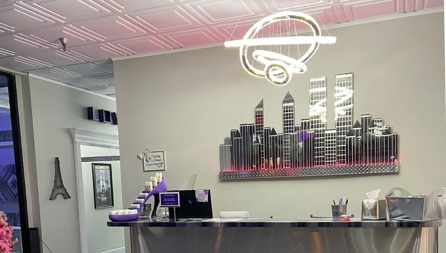 Reception at The Wax Pot - St Pete in St. Petersburg, Florida, featuring modern decor and cityscape art.