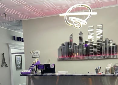 Reception at The Wax Pot - St Pete in St. Petersburg, Florida, featuring modern decor and cityscape art.