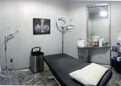 Modern treatment room at The Wax Pot - St Pete, featuring comfortable bed and amenities in St. Petersburg, Florida, US.