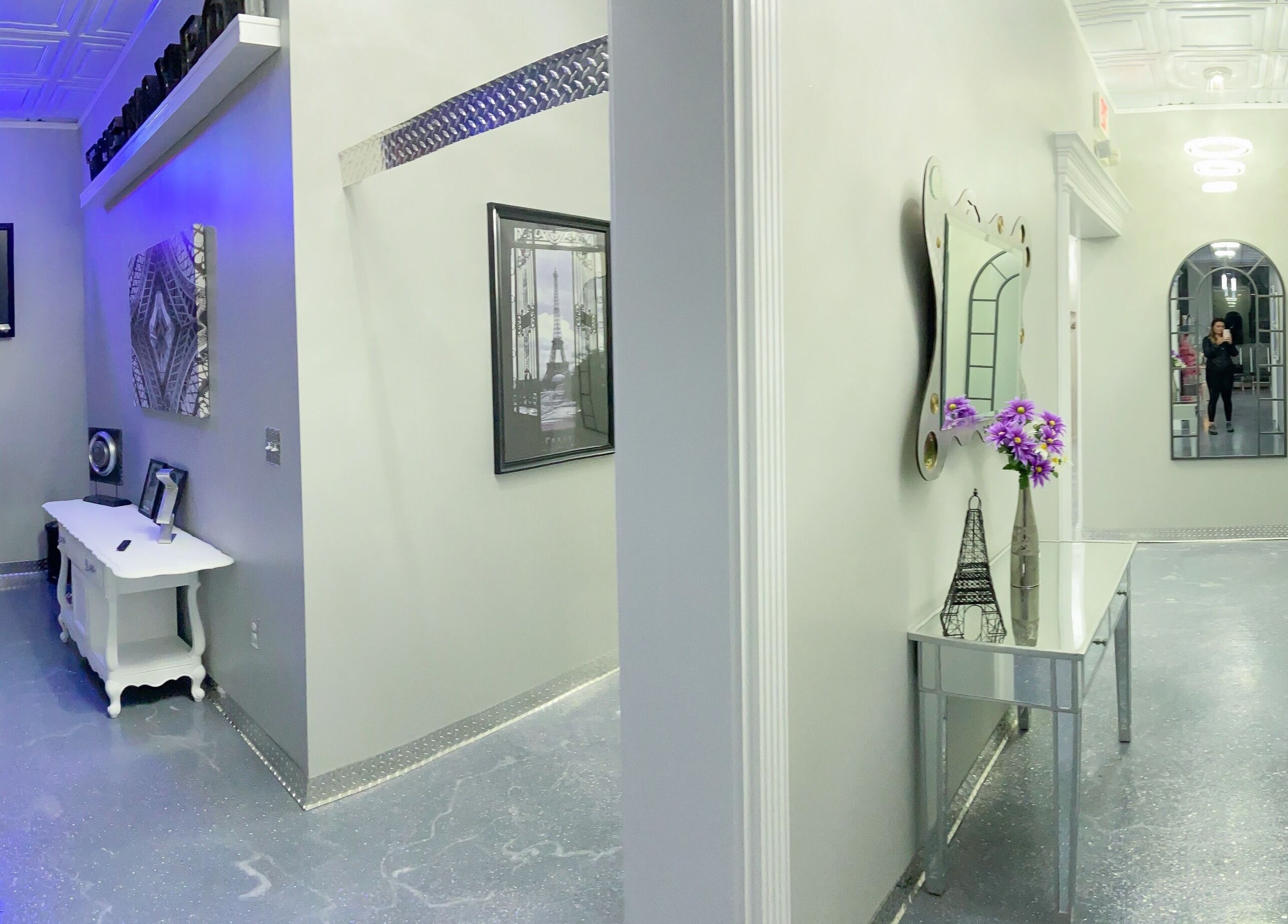 Stylish hallway at The Wax Pot - St Pete in St. Petersburg, Florida, US with modern decor and mirrors.