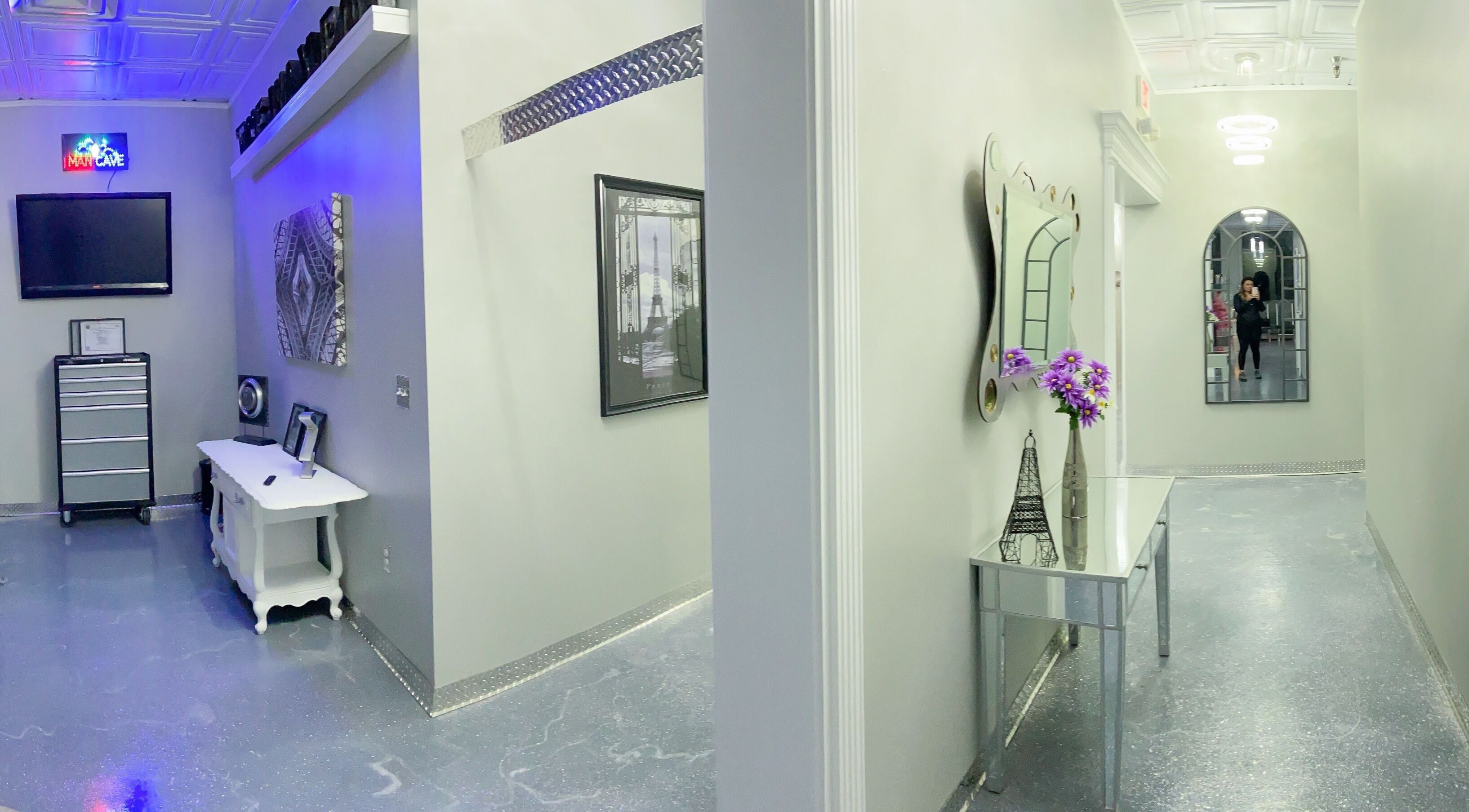 Stylish hallway at The Wax Pot - St Pete in St. Petersburg, Florida, US with modern decor and mirrors.