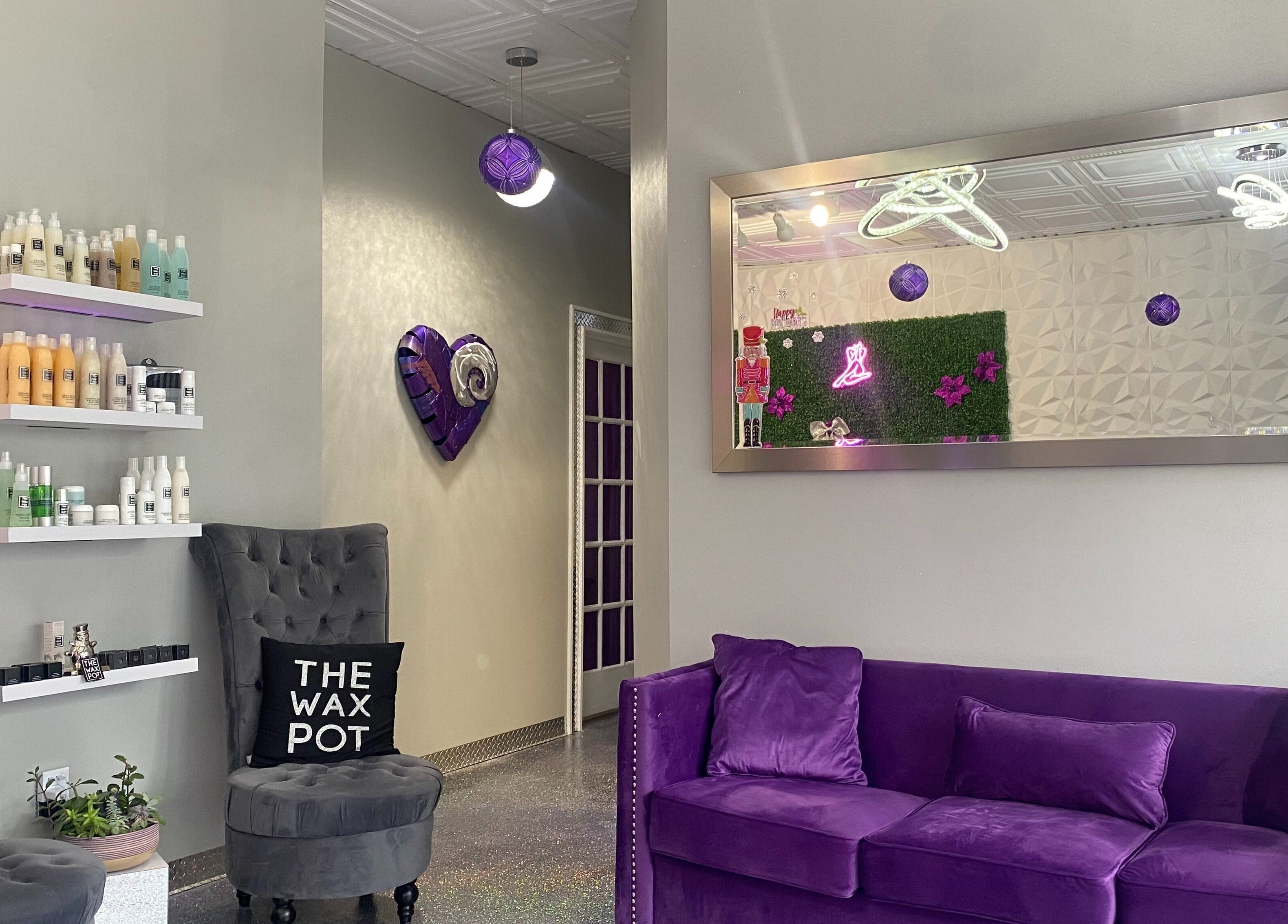Elegant interior of The Wax Pot - Palm Harbor with purple decor and plush seating, Palm Harbor, Florida, US.