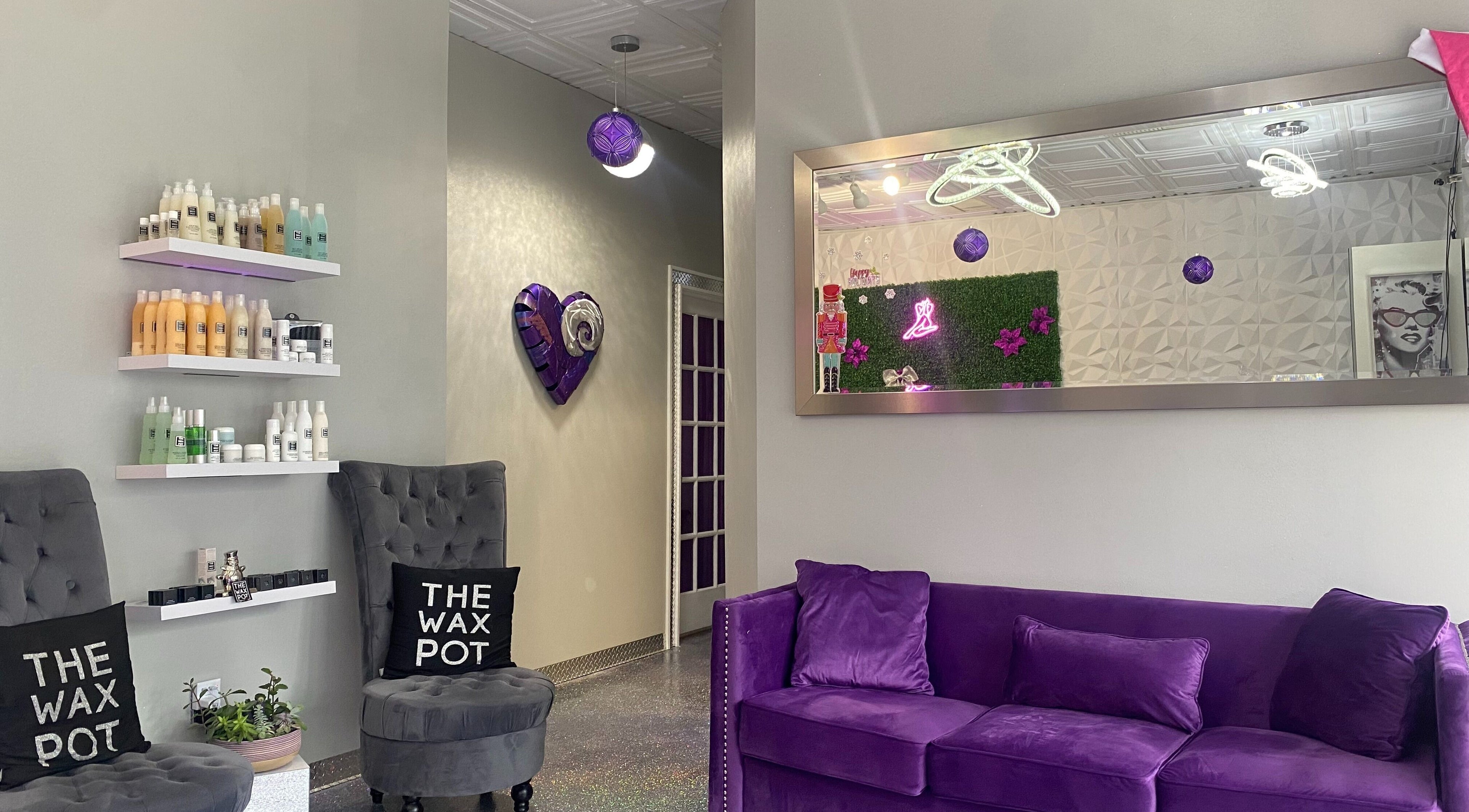 Elegant interior of The Wax Pot - Palm Harbor with purple decor and plush seating, Palm Harbor, Florida, US.