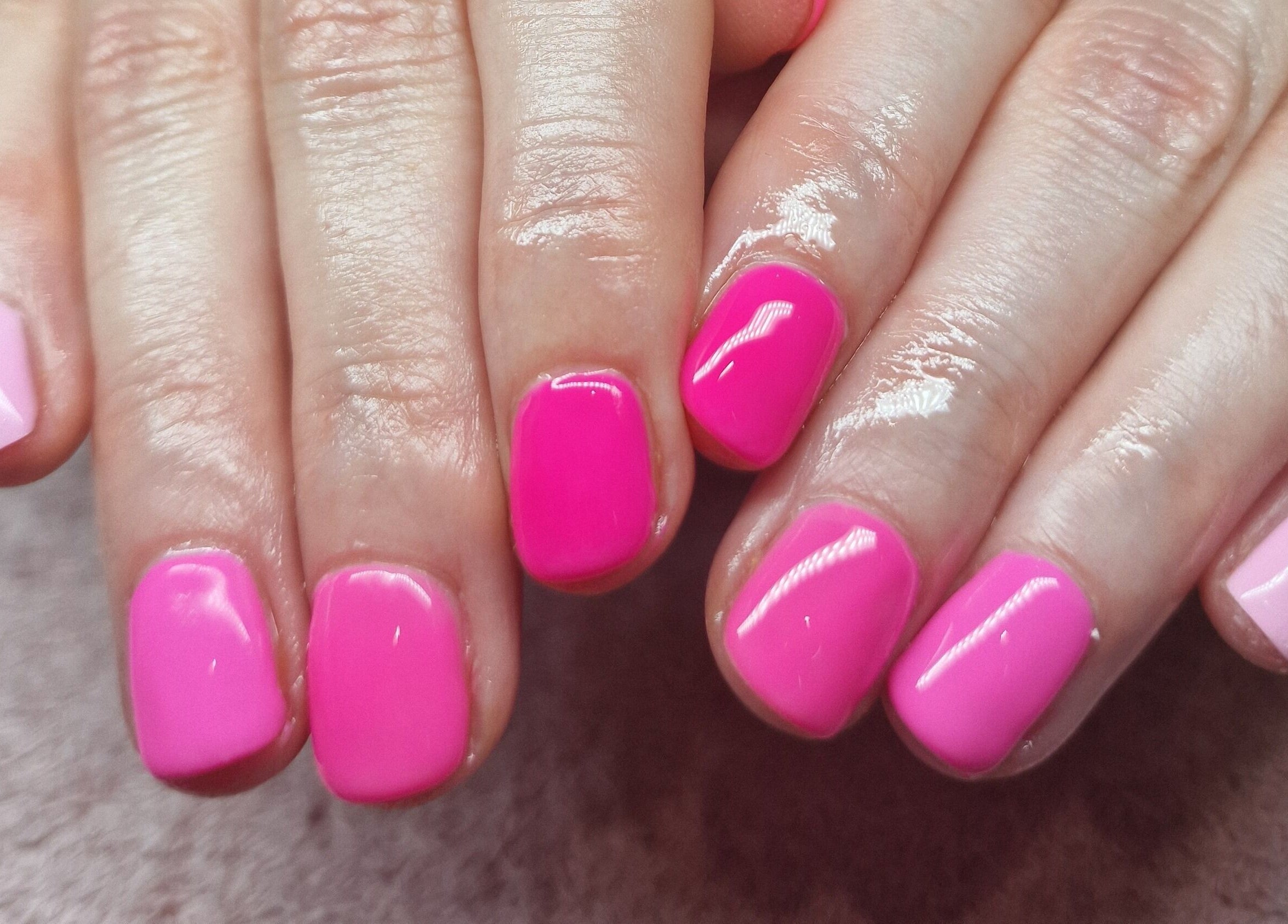Bright pink nails at Adore Beauty, Aberdeen, Scotland, GB showcasing manicure perfection.