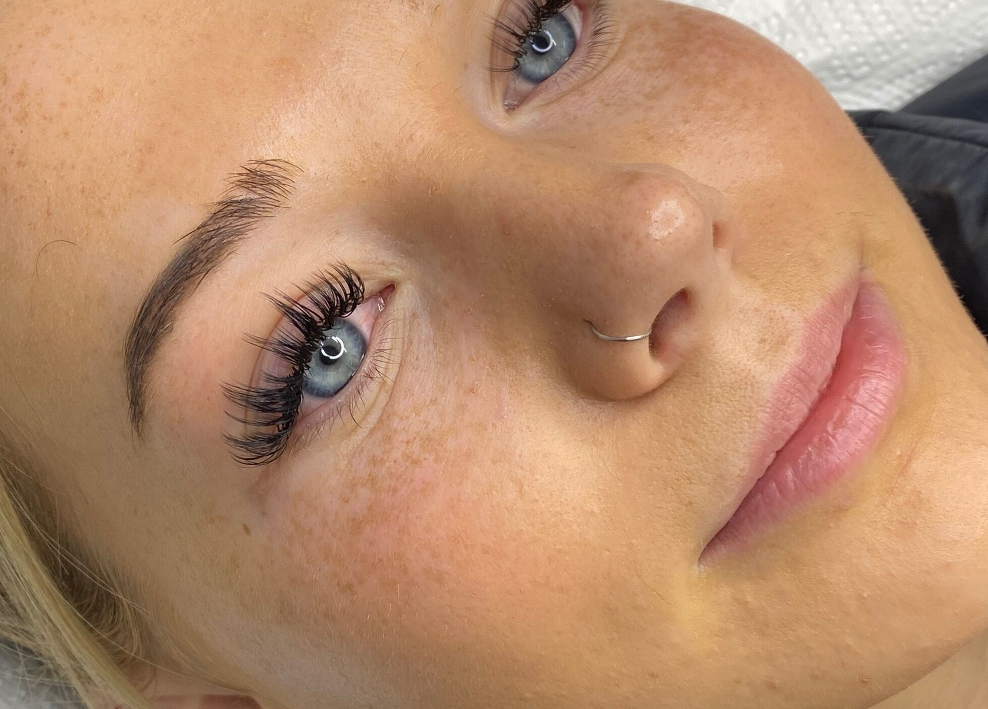 Lash enhancement at Faem Aesthetics, Auckland, NZ. Close-up of expertly applied eyelash extensions.