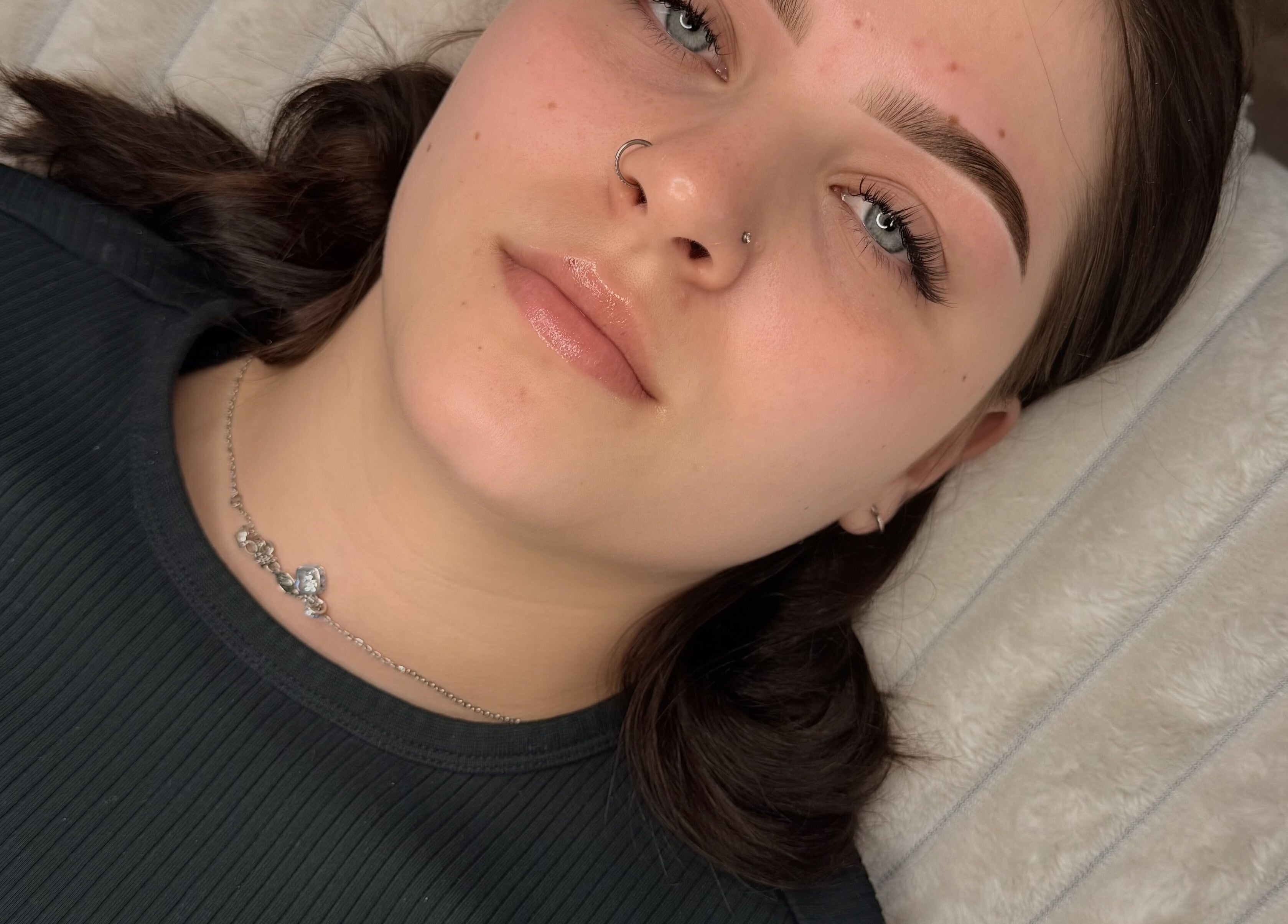 Youthful face post-treatment at Faem Aesthetics, Auckland, Auckland, NZ, showcasing perfect skin and brows.