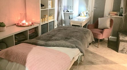 Tranquil treatment room at LHB, London Colney, England. Soft lighting and cozy ambiance enhance relaxation.