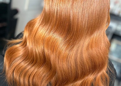 Flowing ginger hair styled at Amy Jane Hairdressing in Stafford, England, GB. Shiny, smooth waves on display.