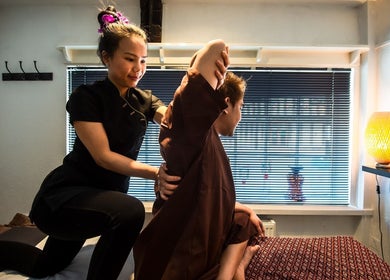 Therapist performing Thai massage stretch at King Thai Therapy Knowle, Knowle, England, GB.