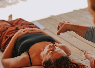 Person receiving relaxation therapy at Exhayl, Epsom, England, GB in a tranquil wooden floor setting.