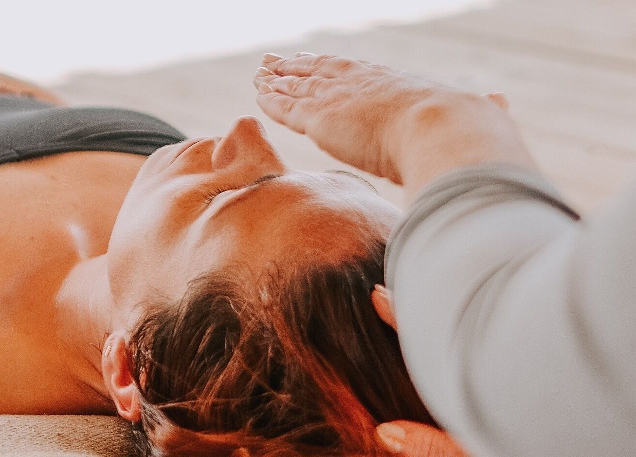 Relaxing therapy session at Exhayl in Epsom, England with expert hands providing healing energy.