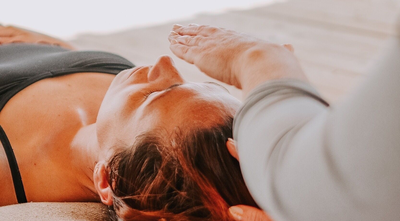 Relaxing therapy session at Exhayl in Epsom, England with expert hands providing healing energy.