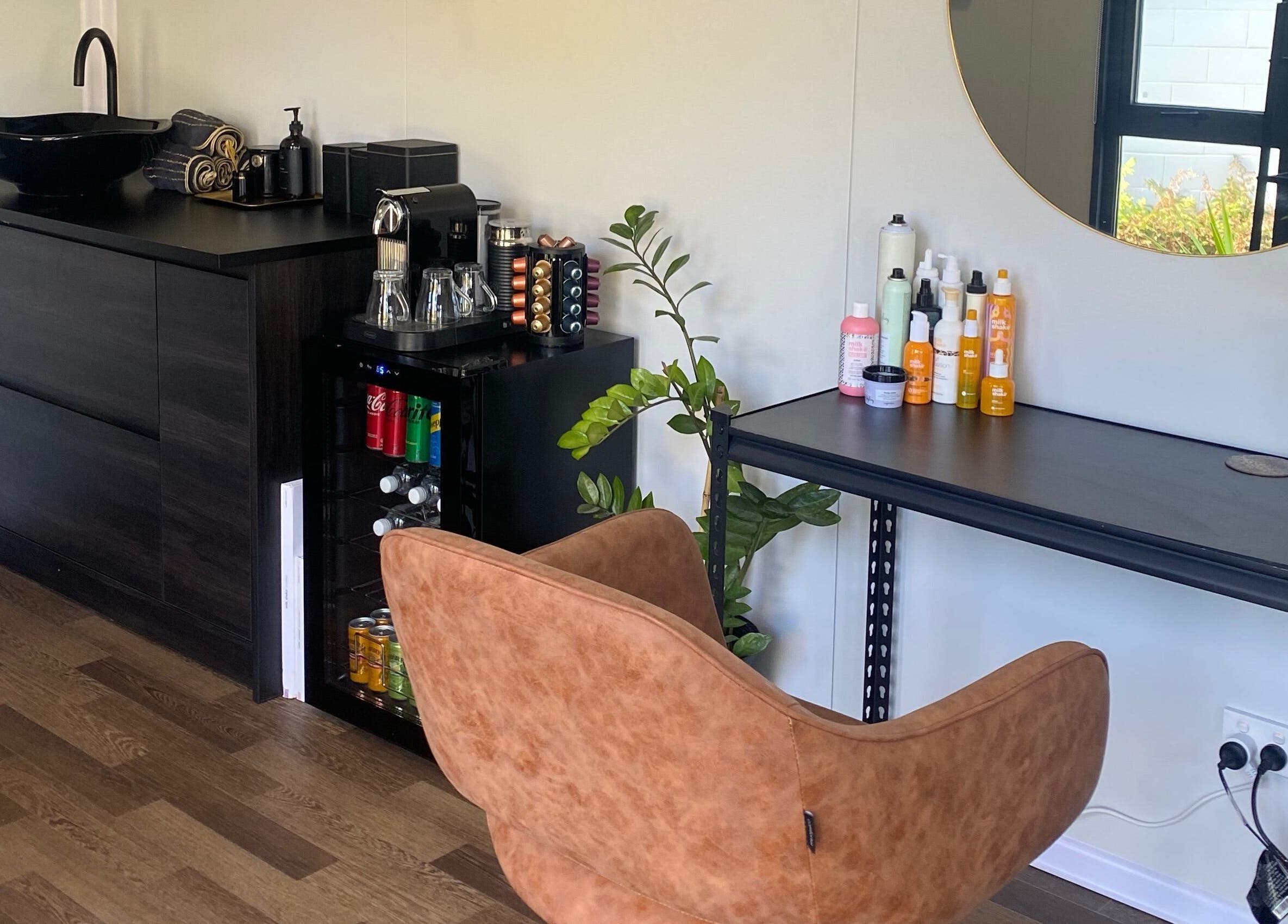 Stylish seating area at Colour Boutique in Christchurch, Canterbury Region, NZ with elegant decor and beauty products.