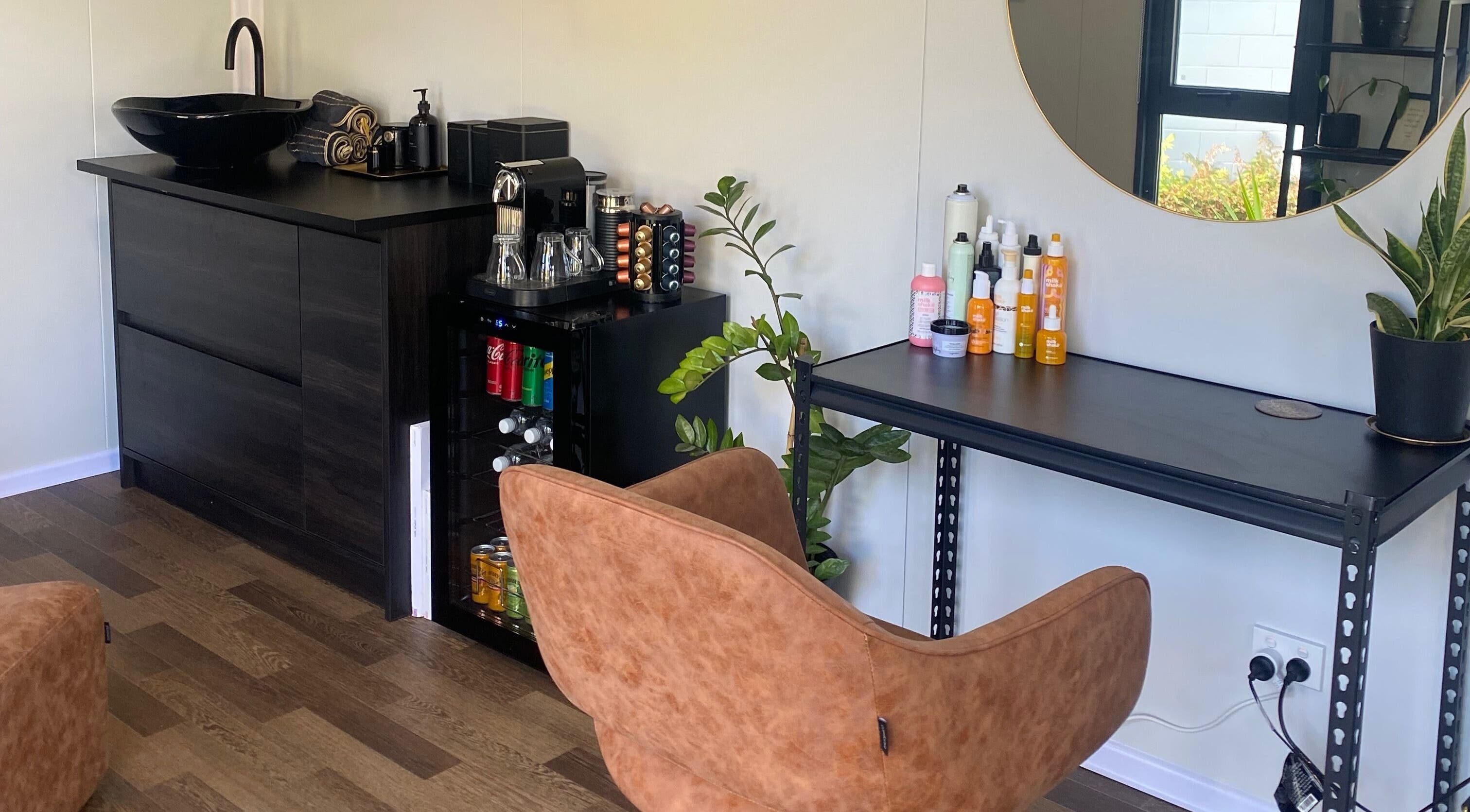 Stylish seating area at Colour Boutique in Christchurch, Canterbury Region, NZ with elegant decor and beauty products.