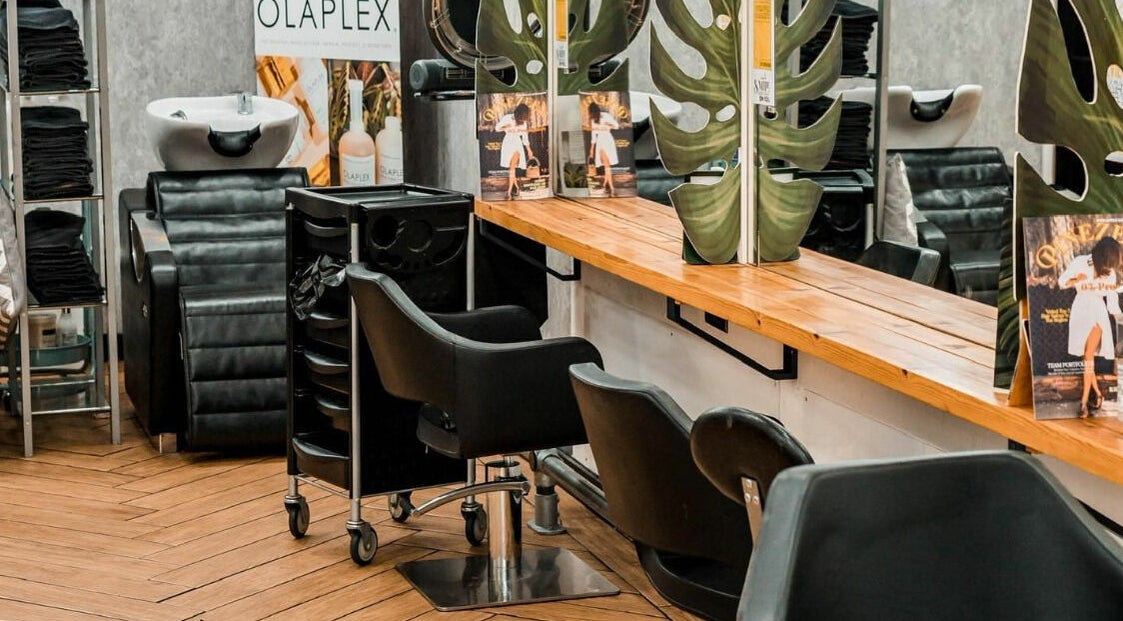 Modern, stylish interior of Pineapple Hair Studio in Rochester, England, GB featuring sleek salon seating.