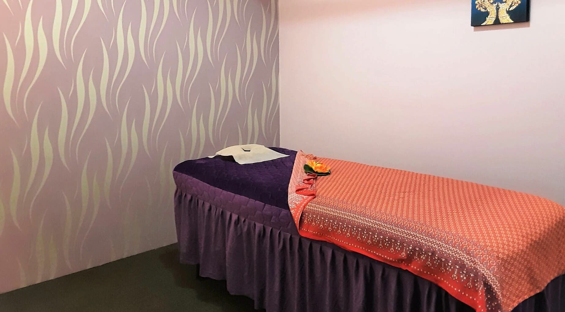 Relaxing massage bed in Hibiscus Traditional Thai Massage, Whangaparāoa, Auckland, NZ, with elegant decor.