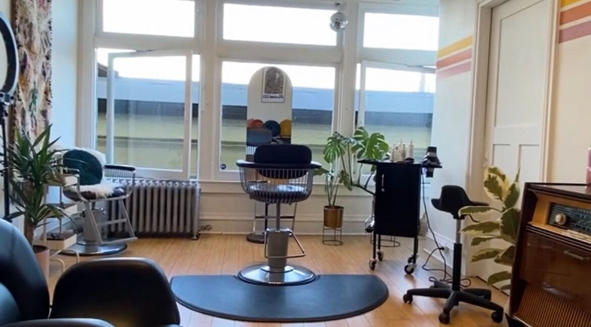 Modern salon interior at Lise Loves Hair in Victoria, British Columbia, CA, showcasing stylish seating and decor.