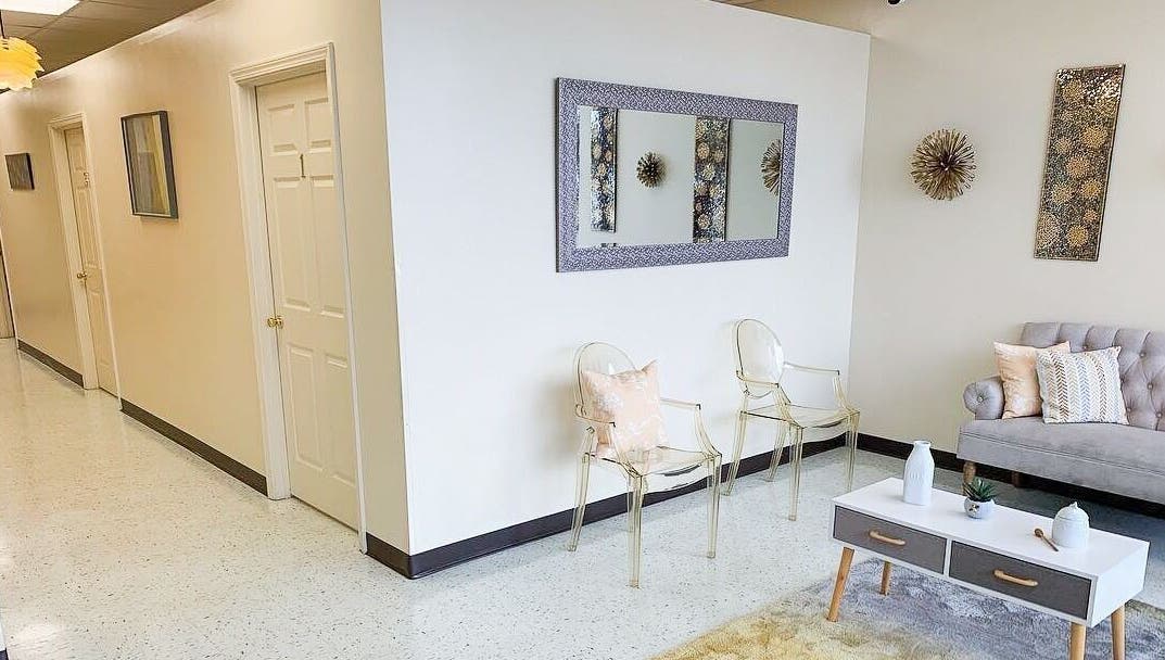 Elegant seating area at Creme + Honey Wax Salon in Fayetteville, North Carolina, US, featuring modern decor.