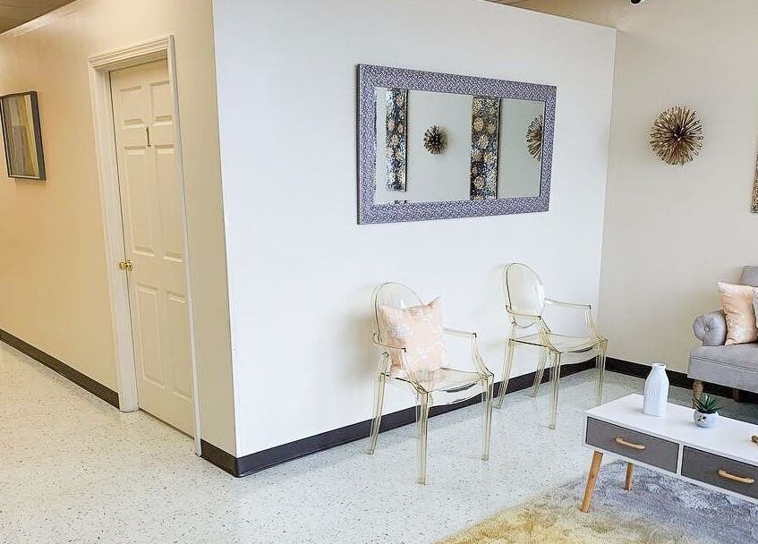 Elegant seating area at Creme + Honey Wax Salon in Fayetteville, North Carolina, US, featuring modern decor.