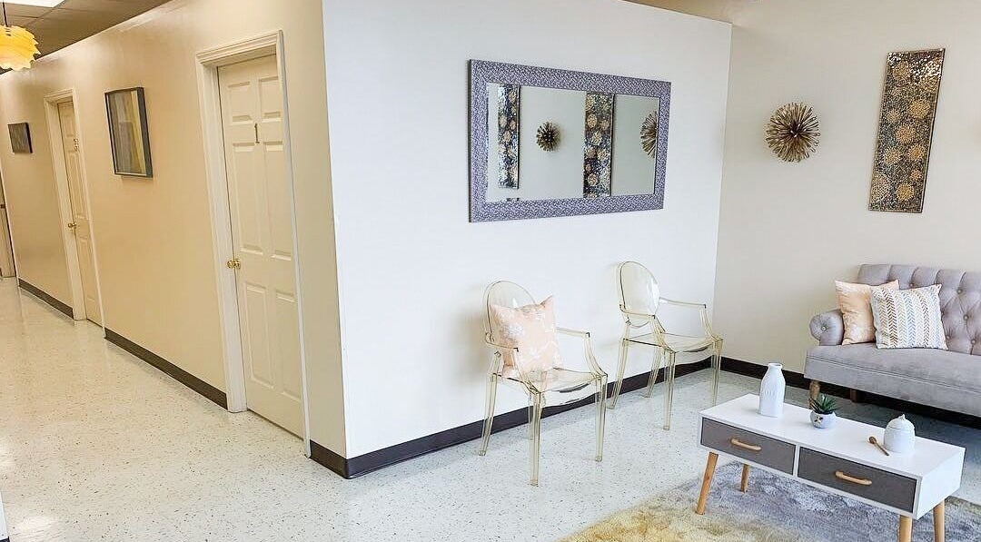 Elegant seating area at Creme + Honey Wax Salon in Fayetteville, North Carolina, US, featuring modern decor.