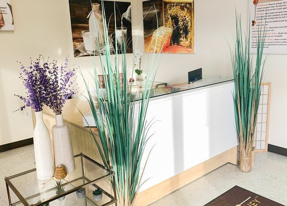 Reception area at Creme + Honey Wax Salon in Fayetteville, North Carolina, US with stylish decor.